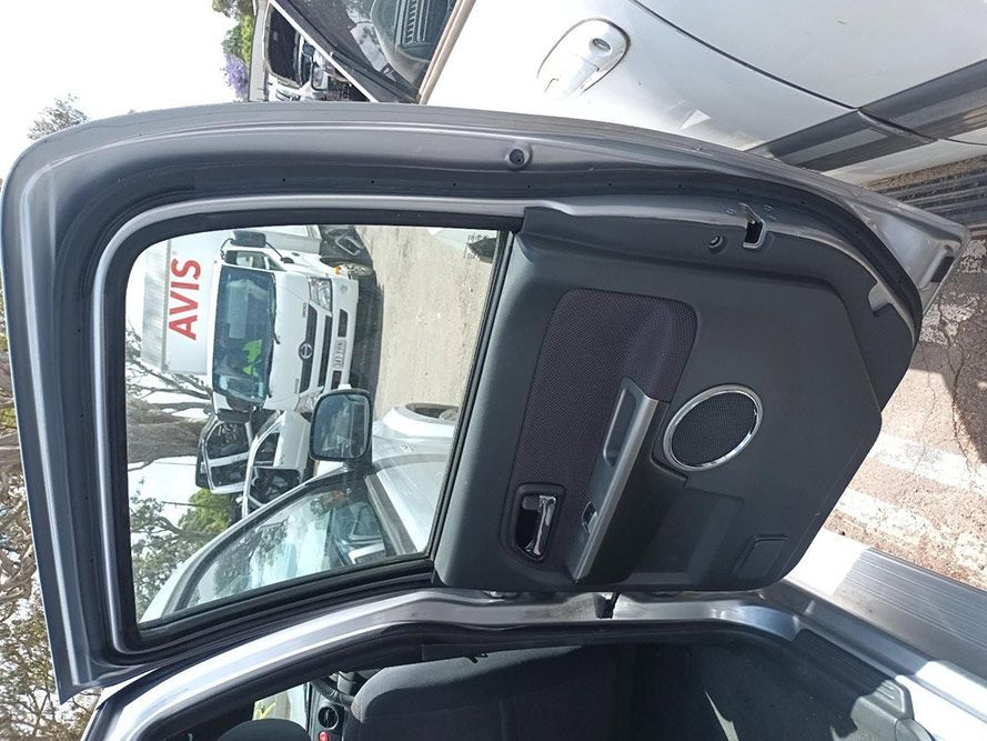 A Car With the Door Open and a Avis Truck in the Background — South West 4WD Wreckers In Harristown, QLD