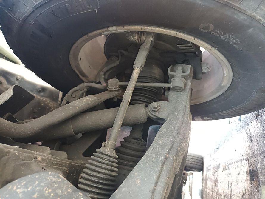 A Close Up of the Underside of a Car With a Tire on It — South West 4WD Wreckers In Harristown, QLD