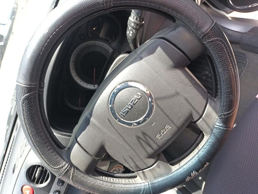 A Close Up of a Steering Wheel With the Word Isuzu on It — South West 4WD Wreckers In Harristown, QLD
