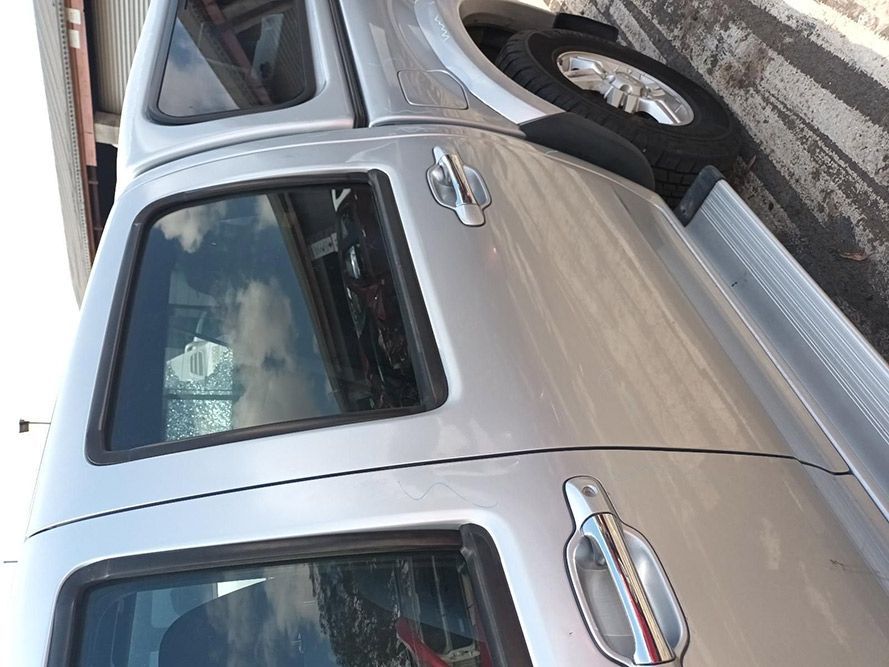 A Silver Truck is Parked on the Side of the Road — South West 4WD Wreckers In Harristown, QLD