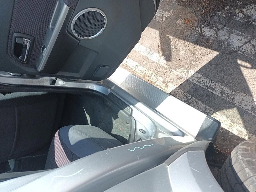 A Person is Sitting in the Back Seat of a Car With the Door Open — South West 4WD Wreckers In Harristown, QLD
