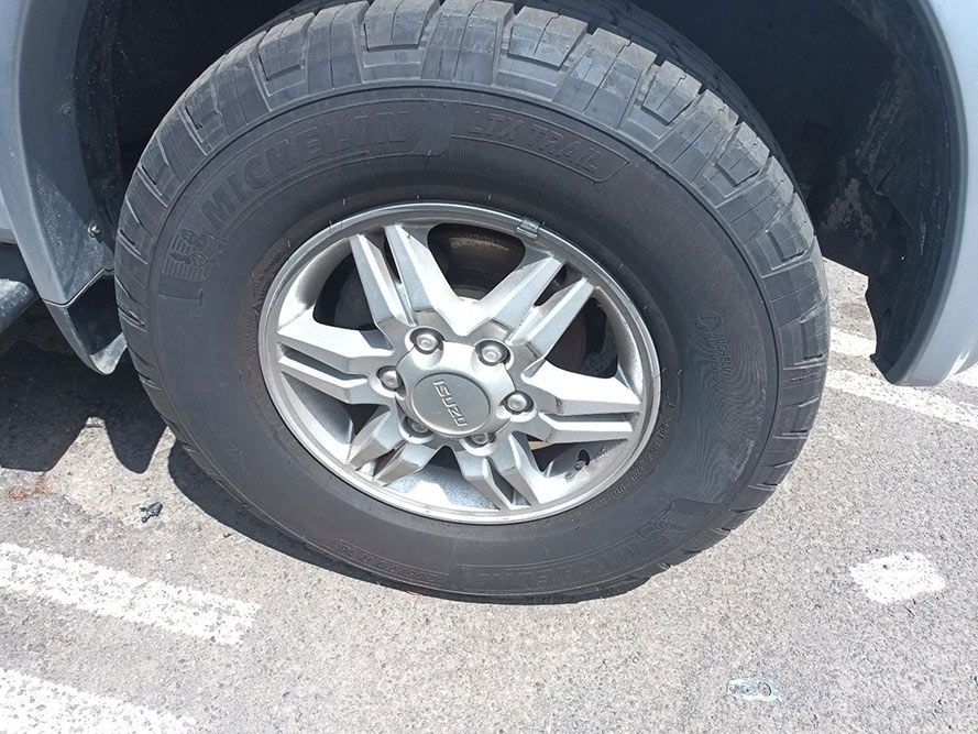 A Close Up of a Tire on a Car in a Parking Lot — South West 4WD Wreckers In Harristown, QLD