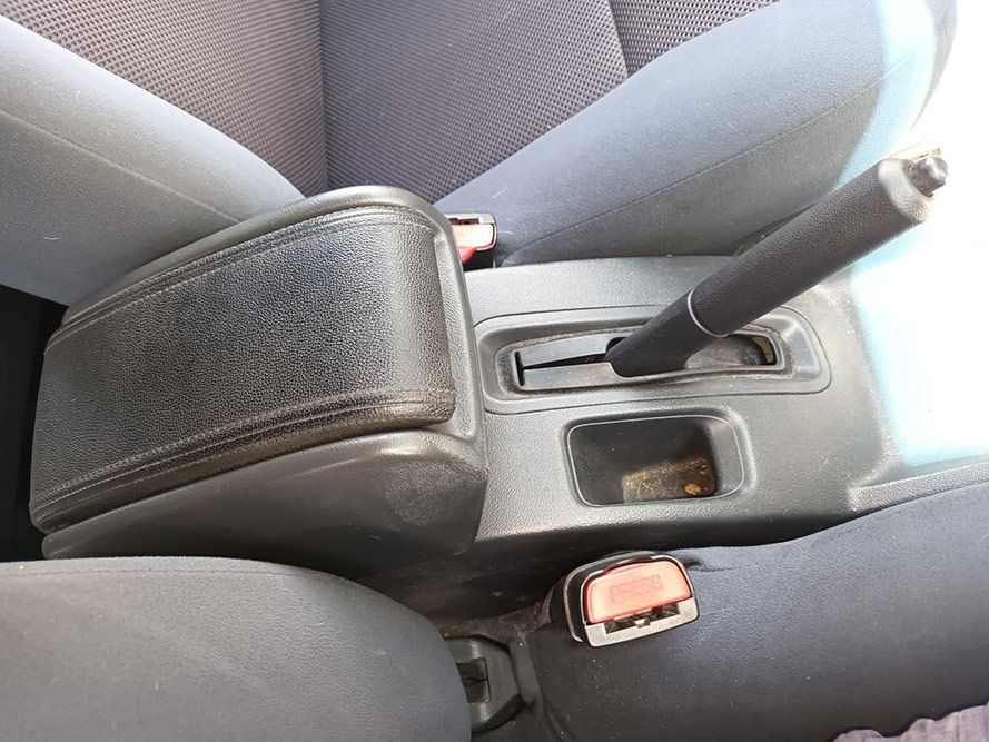 A Person is Sitting in a Car With Their Hand on the Brake Handle — South West 4WD Wreckers In Harristown, QLD