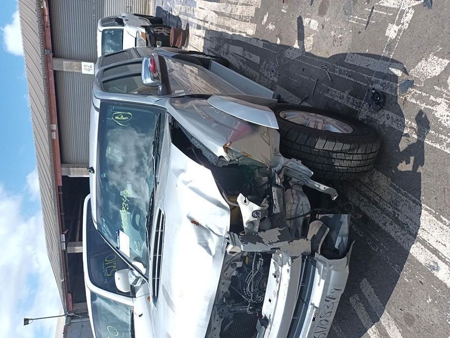 A Damaged Silver Truck is Parked on the Side of the Road — South West 4WD Wreckers In Harristown, QLD