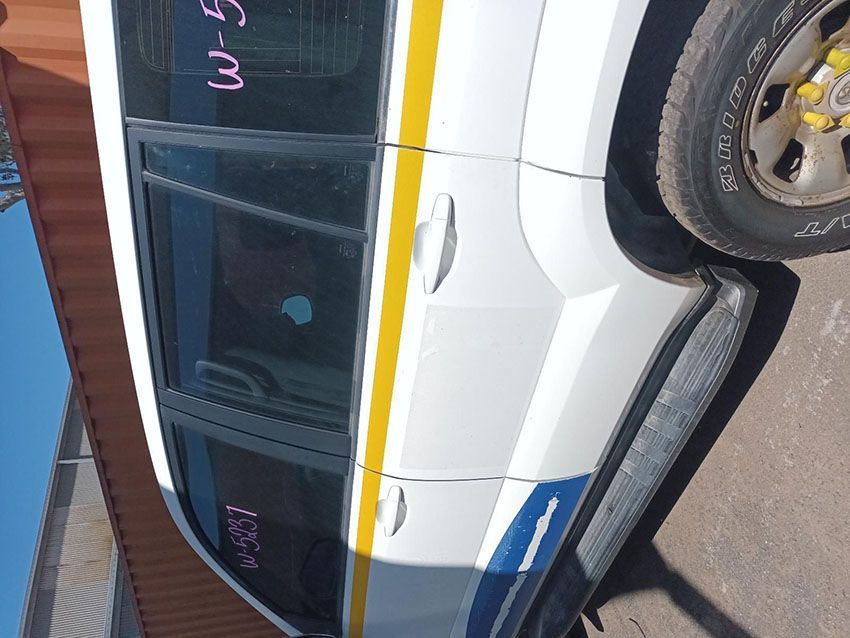 A White Car With a Yellow Stripe on the Side is Parked on the Side of the Road — South West 4WD Wreckers In Brisbane, QLD