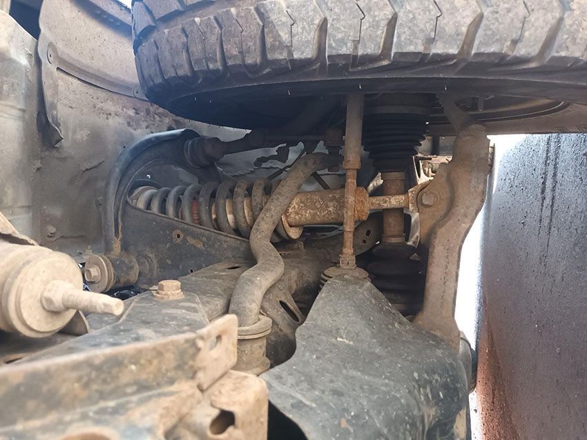 A Close Up of the Underside of a Car With a Tire on It — South West 4WD Wreckers In Brisbane, QLD