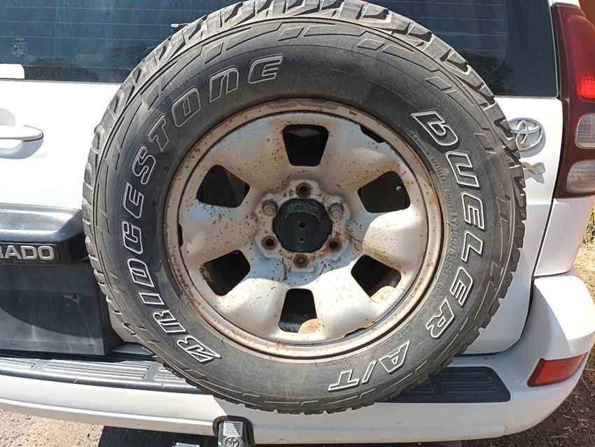 A White SUV With a Tire That Says Bridgestone on It — South West 4WD Wreckers In Brisbane, QLD