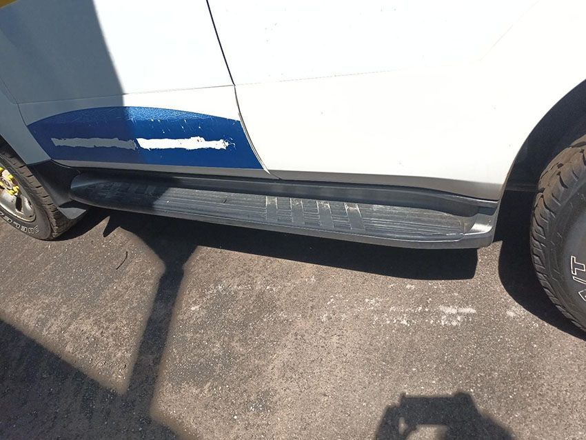 A White Car With Black Side Steps is Parked on the Side of the Road — South West 4WD Wreckers In Brisbane, QLD