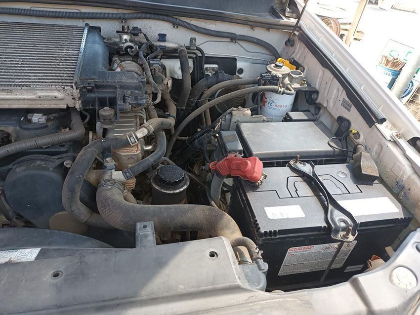 A Close Up of the Engine of a Car With a Battery — South West 4WD Wreckers In Brisbane, QLD