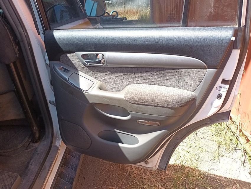 The Back Door of a White Car is Open and Sitting on the Ground — South West 4WD Wreckers In Brisbane, QLD