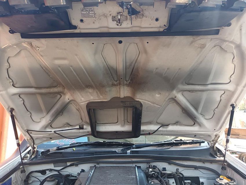 The Hood of a White Car is Open and Shows the Engine — South West 4WD Wreckers In Brisbane, QLD
