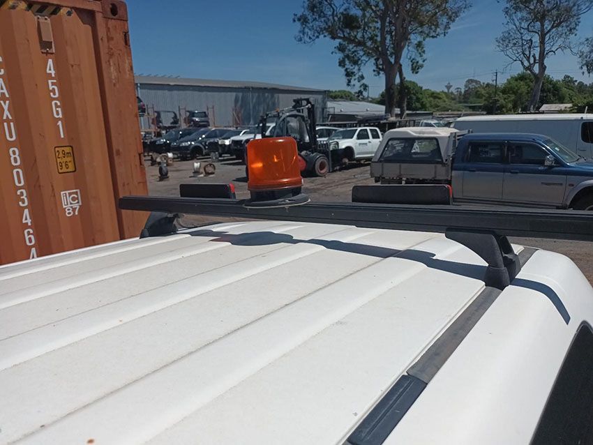 A Roof Rack is Attached to the Roof of a White Van — South West 4WD Wreckers In Brisbane, QLD
