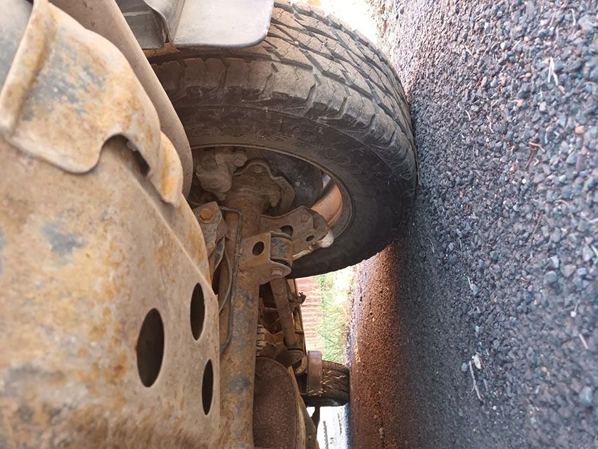 A Close Up of a Tire on a Car on a Gravel Road — South West 4WD Wreckers In Brisbane, QLD
