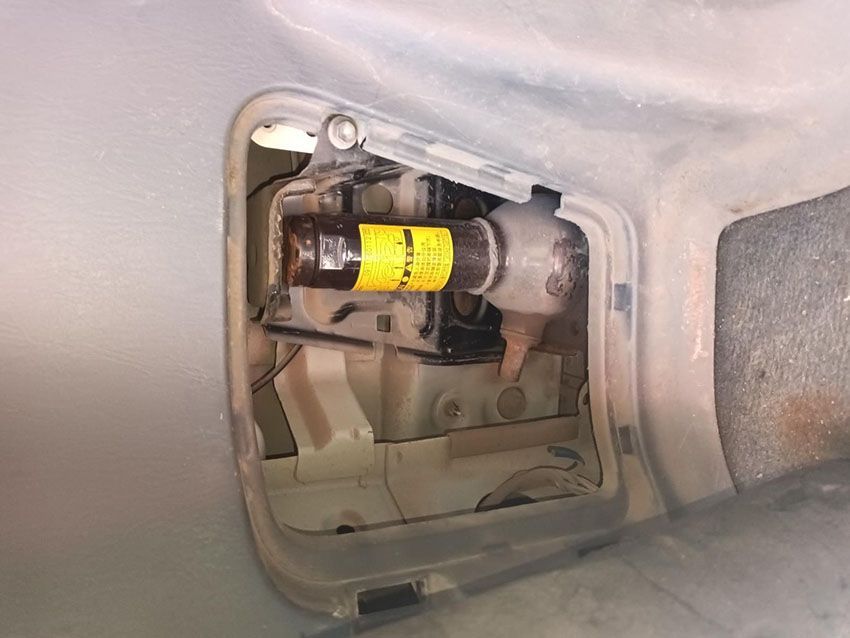 A Yellow Cylinder is Sitting in the Trunk of a Car — South West 4WD Wreckers In Brisbane, QLD