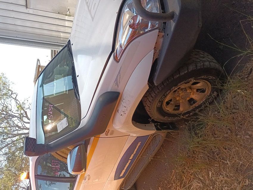 A White Truck With a Snorkel on the Hood is Parked in the Dirt — South West 4WD Wreckers In Brisbane, QLD