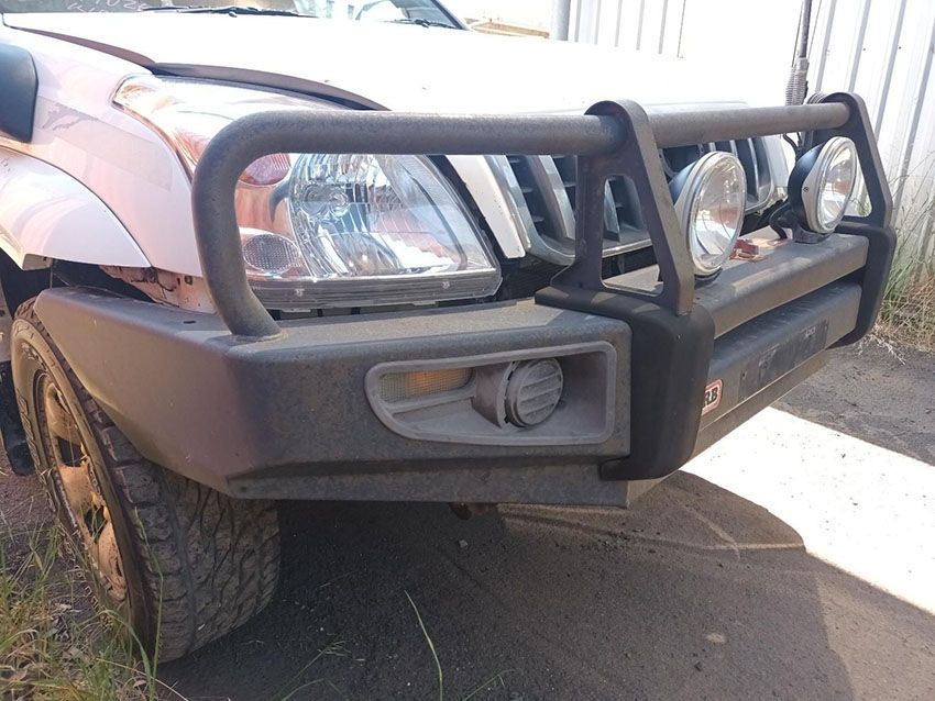A White Truck With a Black Bumper is Parked on the Side of the Road — South West 4WD Wreckers In Brisbane, QLD