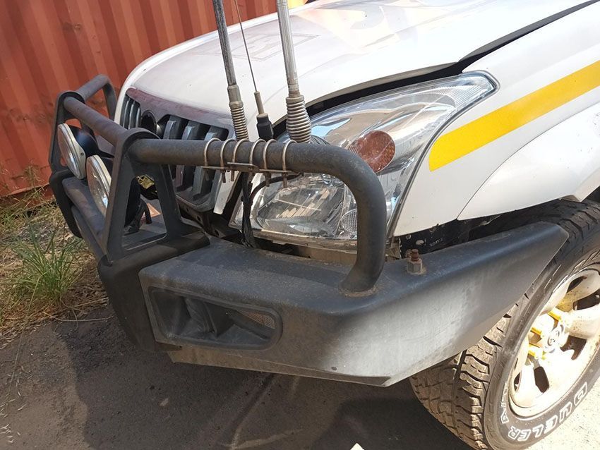 A White Truck With a Yellow Stripe on the Side is Parked in Front — South West 4WD Wreckers In Brisbane, QLD