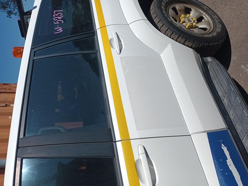 A White Van With a Yellow and Blue Stripe on the Side — South West 4WD Wreckers In Brisbane, QLD