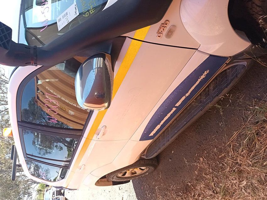 A White Car With a Yellow Stripe on the Side is Parked on the Ground — South West 4WD Wreckers In Brisbane, QLD