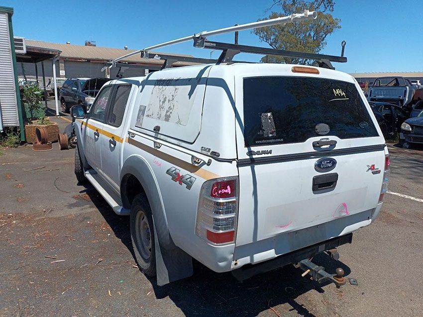 A White Truck With a Canopy on Top of It is Parked in a Parking Lot — South West 4WD Wreckers In Brisbane, QLD