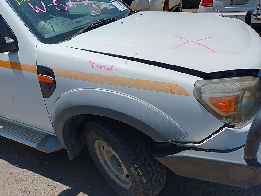 A White Truck With a Broken Hood is Parked on the Side of the Road — South West 4WD Wreckers In Brisbane, QLD