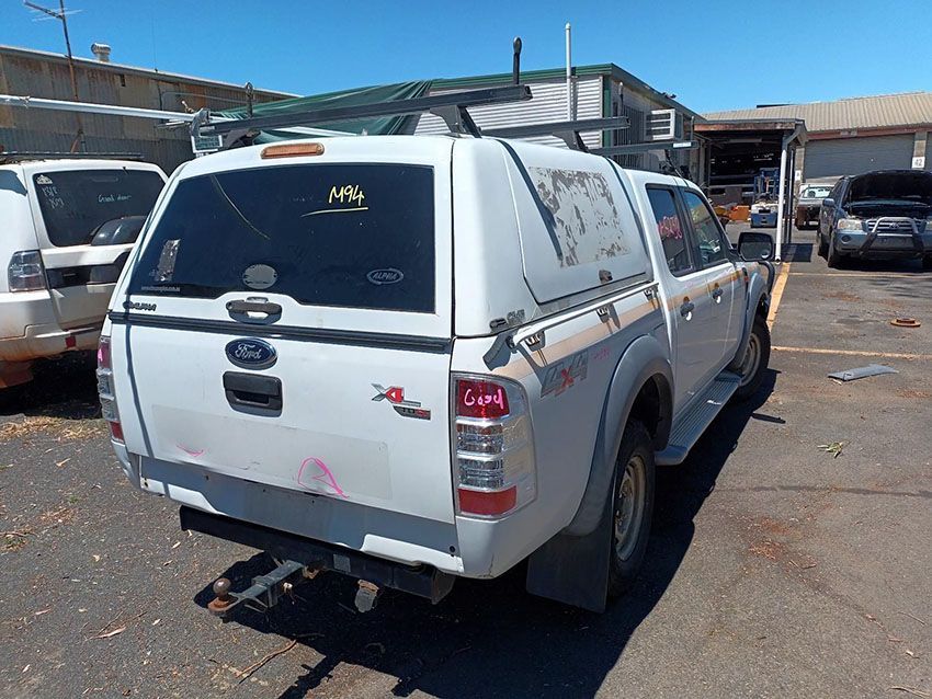 A White Truck With a Canopy is Parked in a Parking Lot — South West 4WD Wreckers In Brisbane, QLD