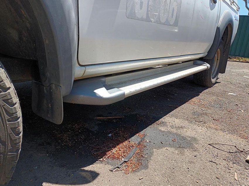 A Silver Truck With Side Steps is Parked on the Side of the Road — South West 4WD Wreckers In Brisbane, QLD