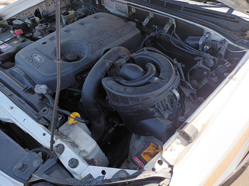 The Engine of a White Car is Shown With the Hood Open — South West 4WD Wreckers In Brisbane, QLD