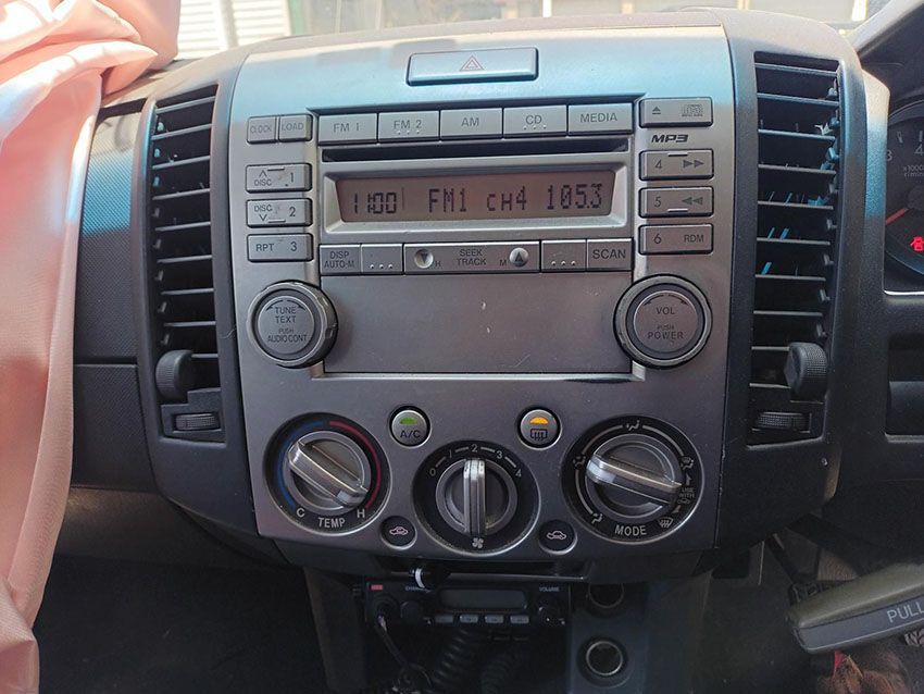 A Car Radio Displays the Time as 1853 — South West 4WD Wreckers In Brisbane, QLD