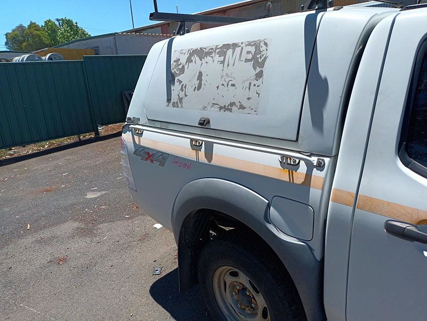 A White Truck With a Canopy on the Back is Parked in a Parking Lot — South West 4WD Wreckers In Brisbane, QLD