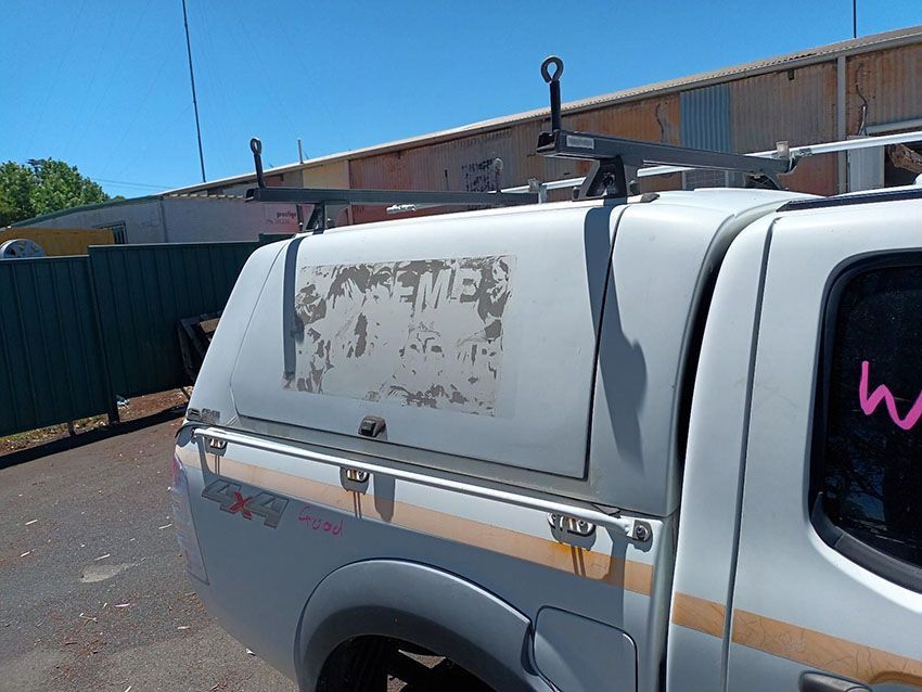 A White Truck With a Canopy on the Back is Parked in a Parking Lot — South West 4WD Wreckers In Brisbane, QLD
