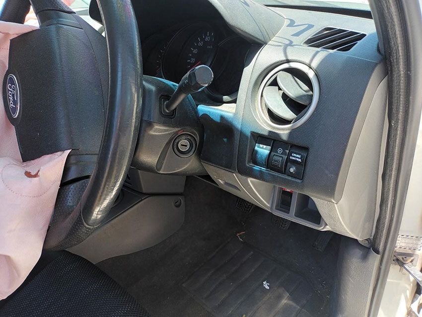 A Person is Holding a Steering Wheel in a Ford Car — South West 4WD Wreckers In Brisbane, QLD