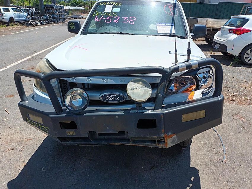 A White Ford Truck With a Black Bumper is Parked on the Side of the Road — South West 4WD Wreckers In Brisbane, QLD