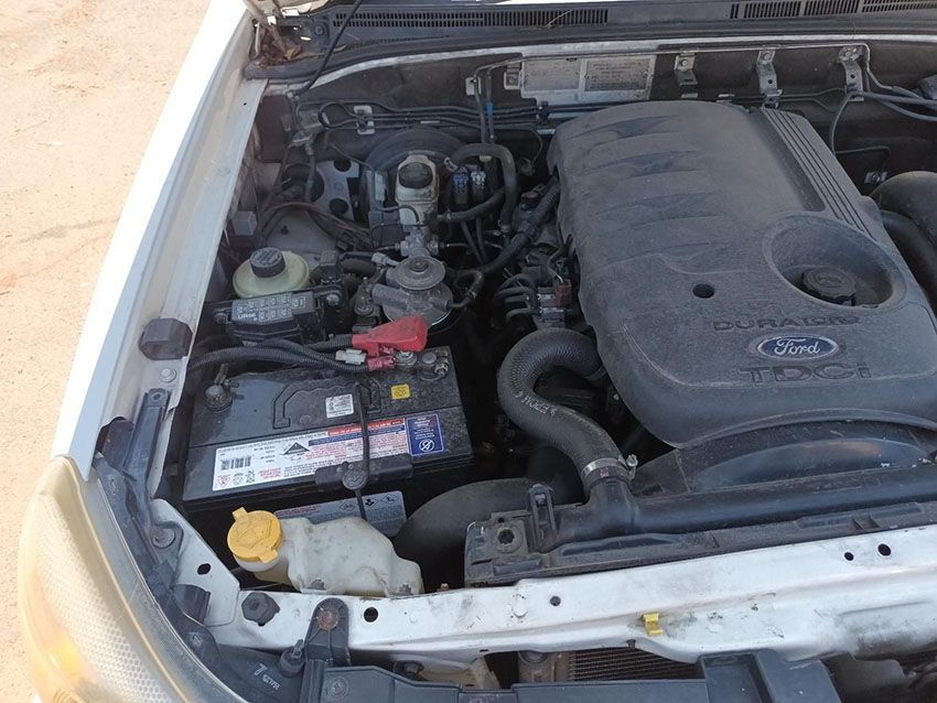 The Engine of a White Ford Truck is Visible Under the Hood — South West 4WD Wreckers In Brisbane, QLD