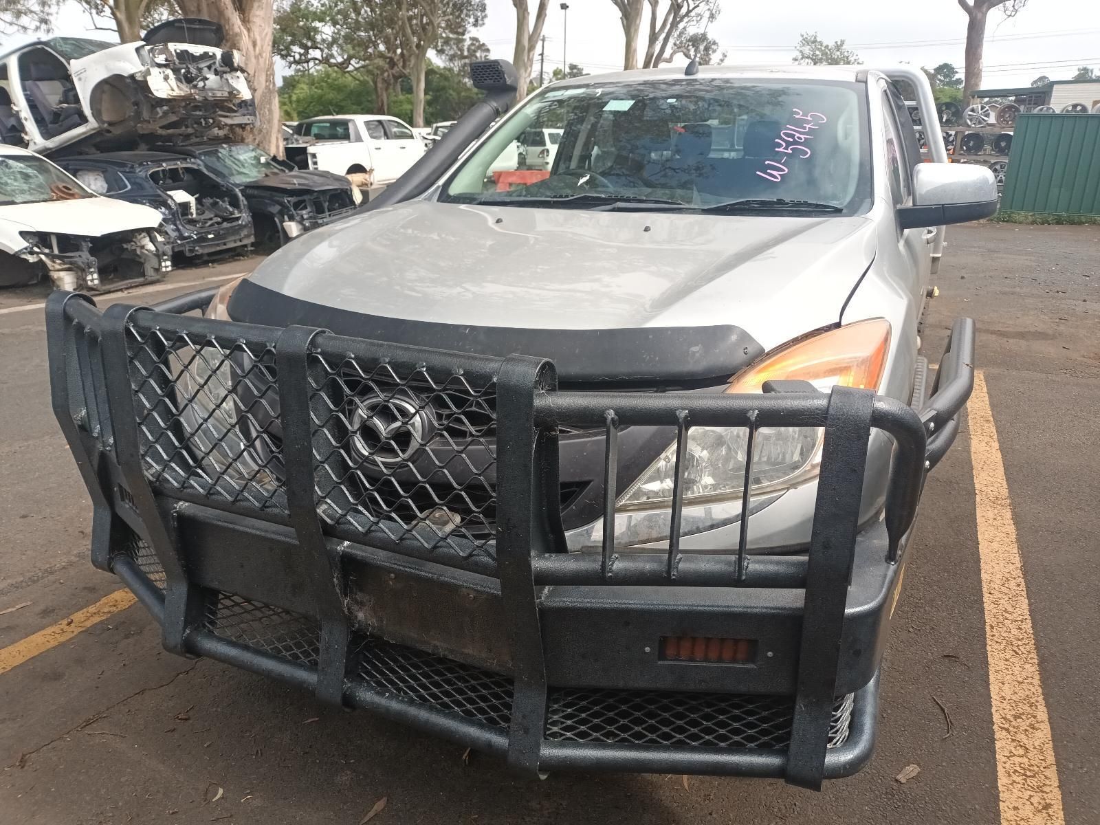 A Silver Car with a Black Bumper is Parked in a Parking Lot — South West 4WD Wreckers in Harristown, QLD