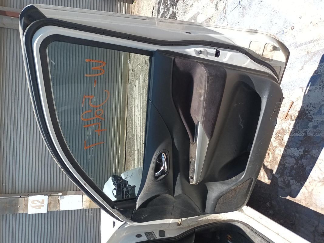 A White Car with the Door Open is Parked in Front of a Building — South West 4WD Wreckers In Brisbane, QLD