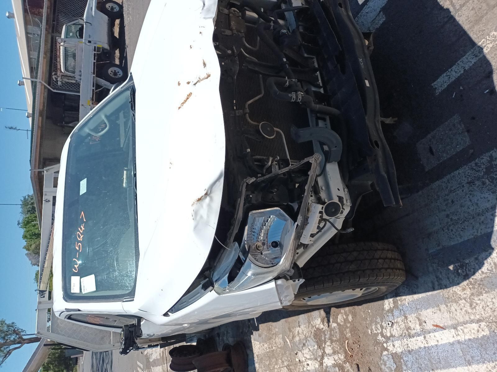 A Damaged White Truck is Parked on the Side of the Road — South West 4WD Wreckers In Brisbane, QLD