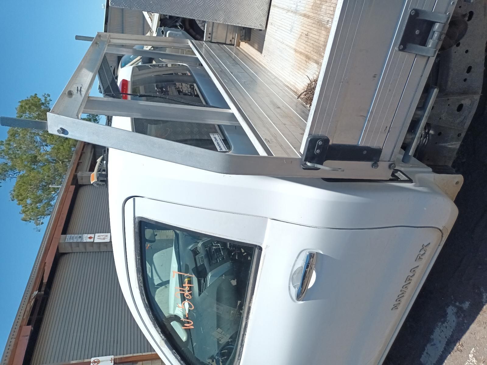 A White Truck is Parked in Front of a Building — South West 4WD Wreckers In Brisbane, QLD