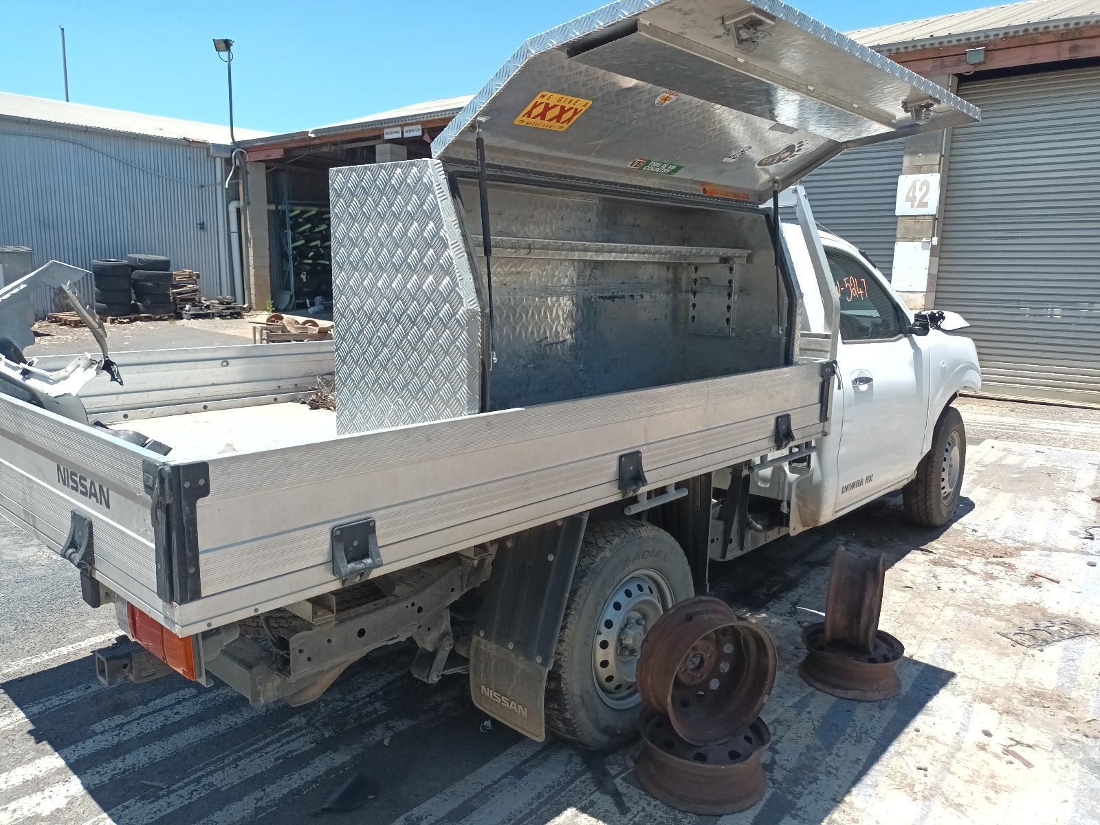 A White Truck with a Toolbox on the Back is Parked in a Parking Lot — South West 4WD Wreckers In Brisbane, QLD