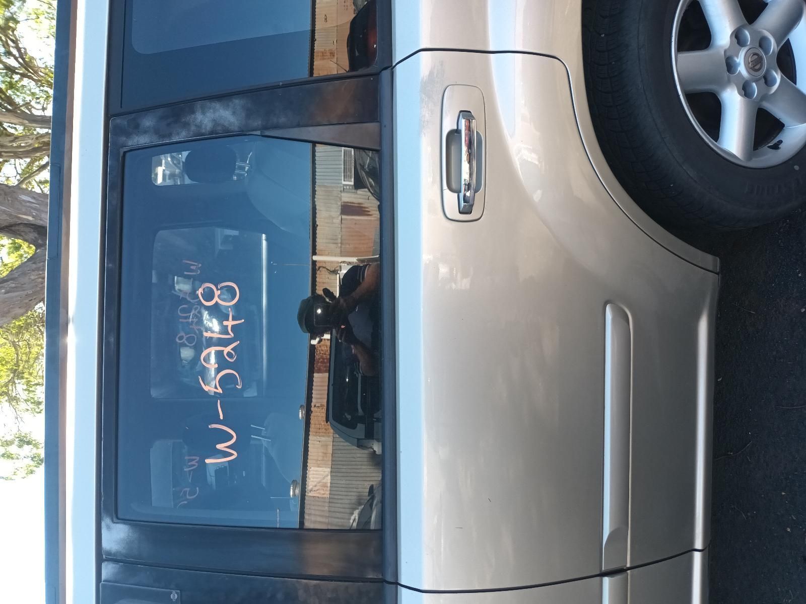 A Silver Car with Numbers Written on Window — South West 4WD Wreckers in Harristown, QLD