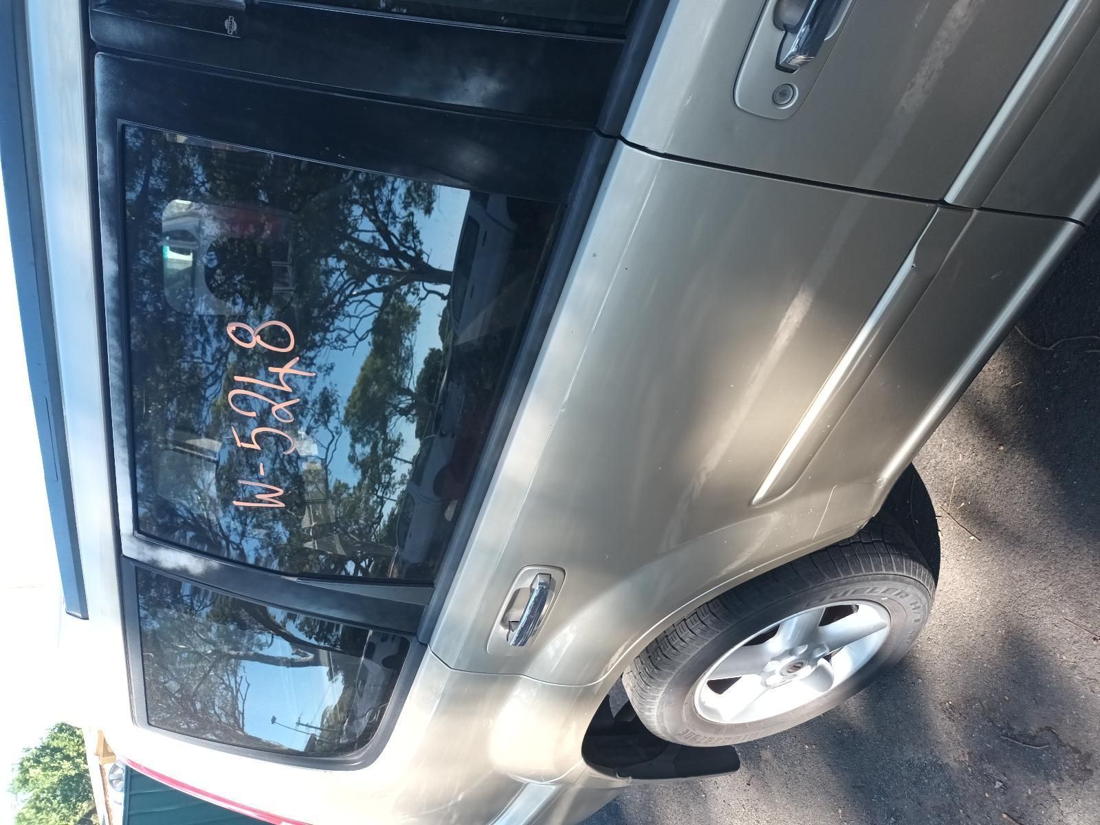 A Silver SUV with Written Numbers on the Back Window — South West 4WD Wreckers in Harristown, QLD