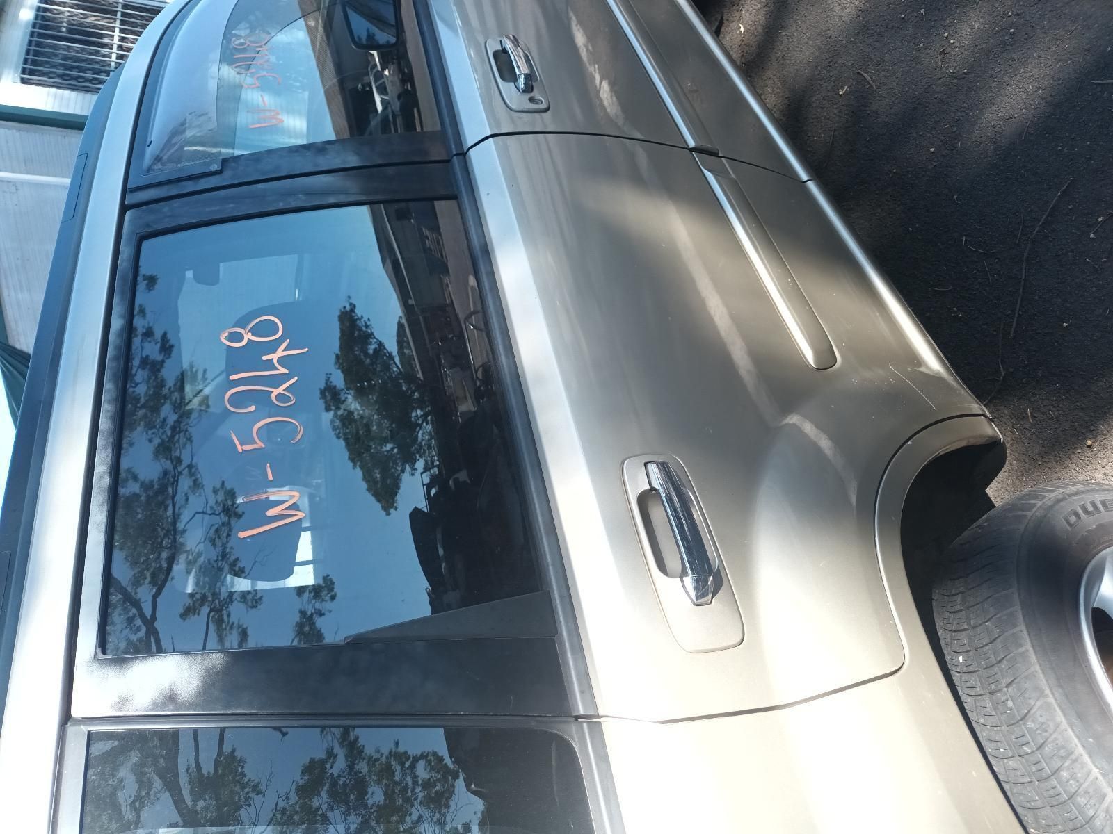 A Silver Car with a Numbers Written on the Door — South West 4WD Wreckers in Harristown, QLD