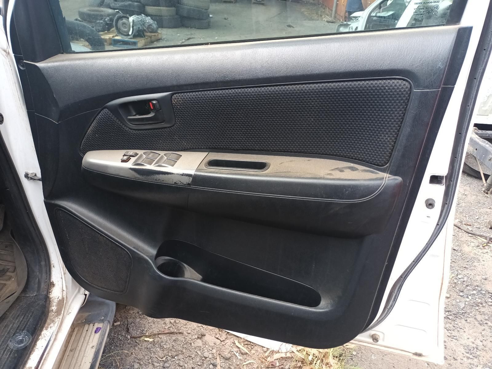 A White Car with the Door Open is Parked on the Side of the Road — South West 4WD Wreckers In Brisbane, QLD