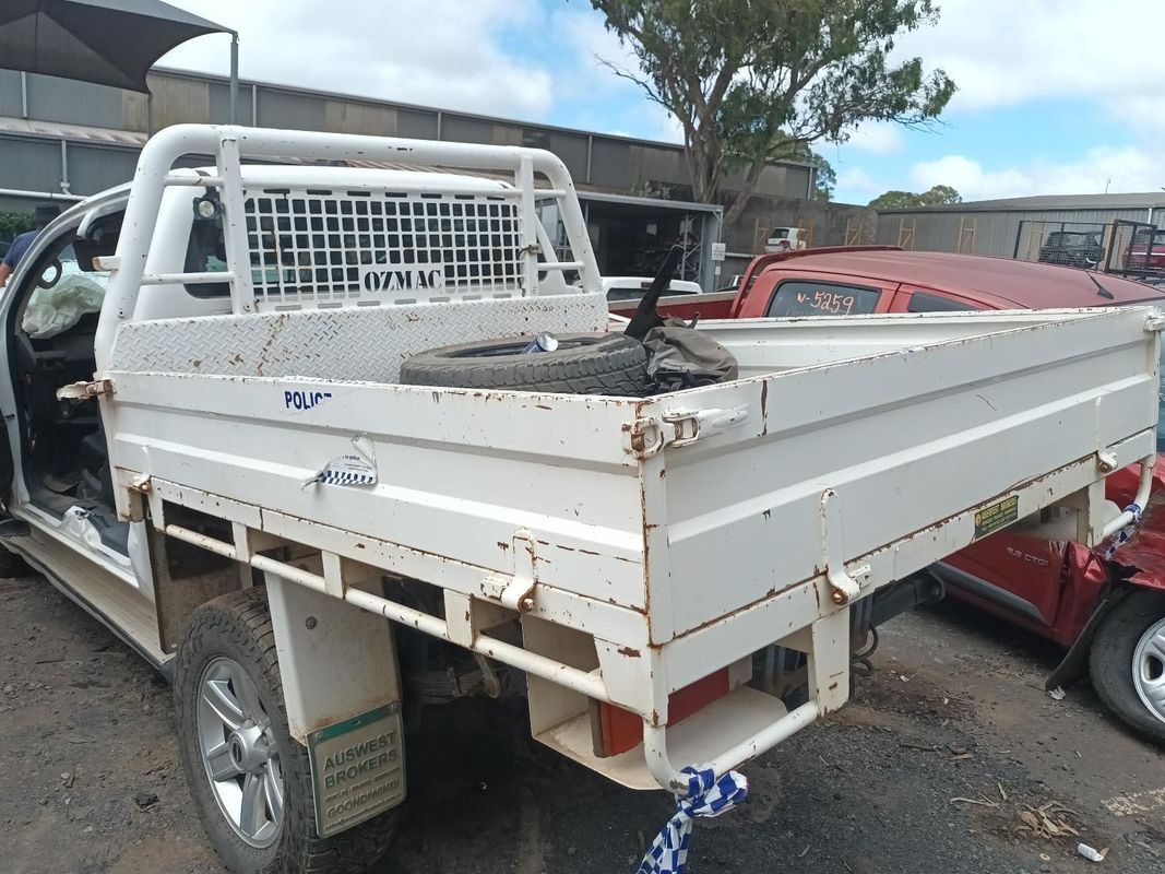 A White Truck with a Tray on the Back is Parked in a Lot — South West 4WD Wreckers In Brisbane, QLD