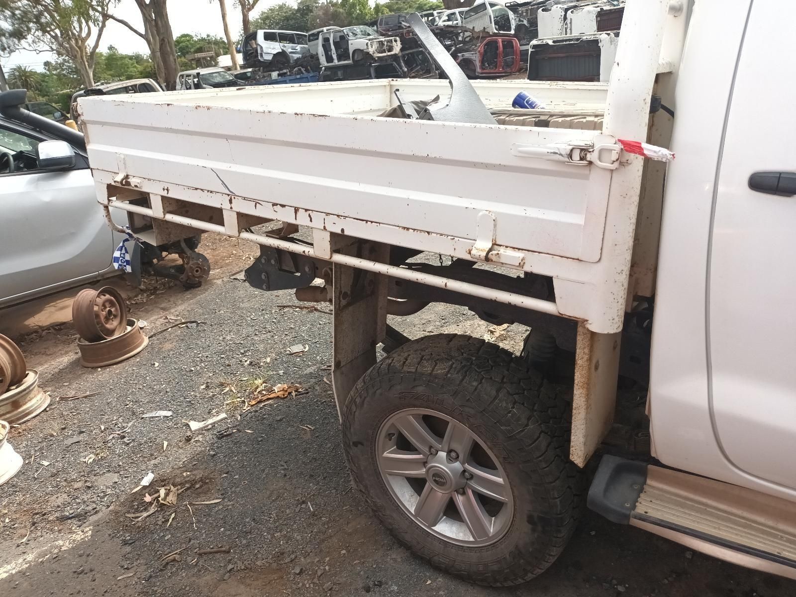 A White Truck with a Flat Bed is Parked in a Lot — South West 4WD Wreckers In Brisbane, QLD