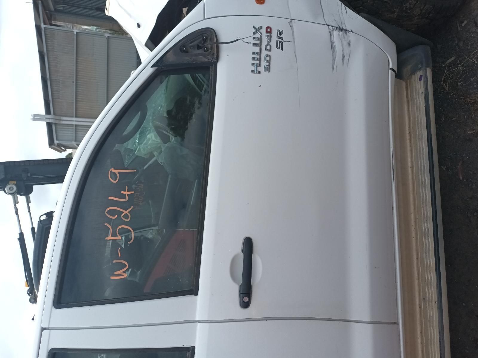 A White Truck with a Broken Door is Sitting on the Ground — South West 4WD Wreckers In Brisbane, QLD