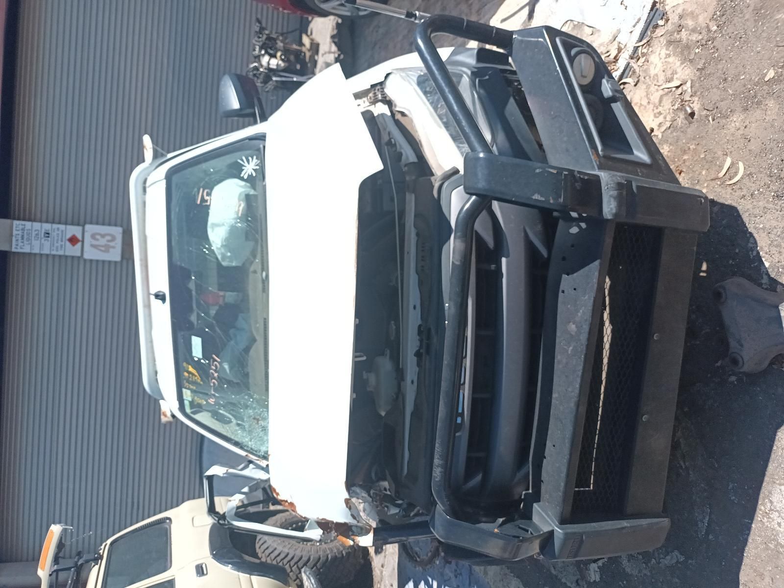 A White Truck with a Black Bumper is Sitting on the Ground — South West 4WD Wreckers in Harristown, QLD