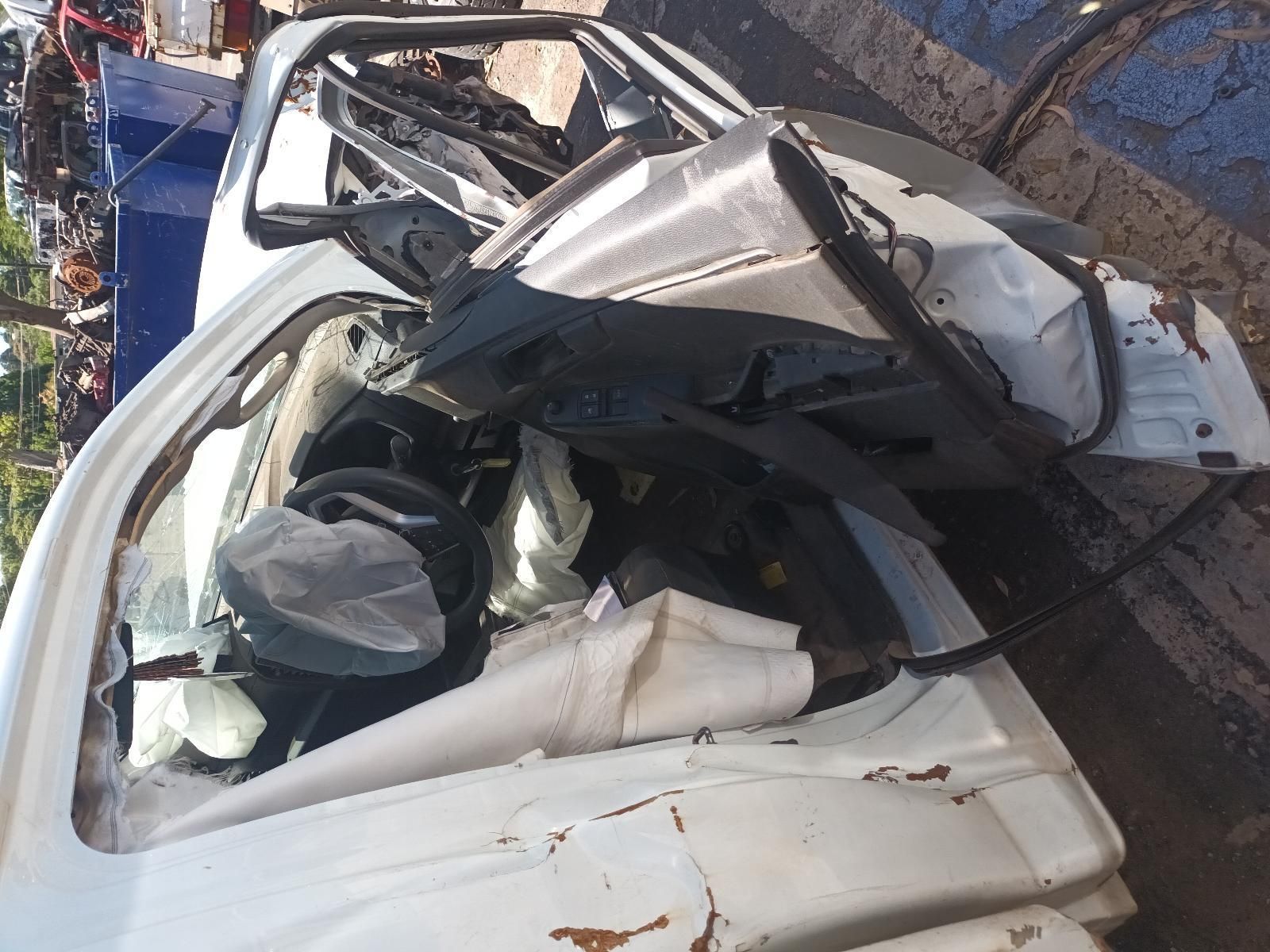 A White Car is Sitting on the Side of the Road — South West 4WD Wreckers in Harristown, QLD