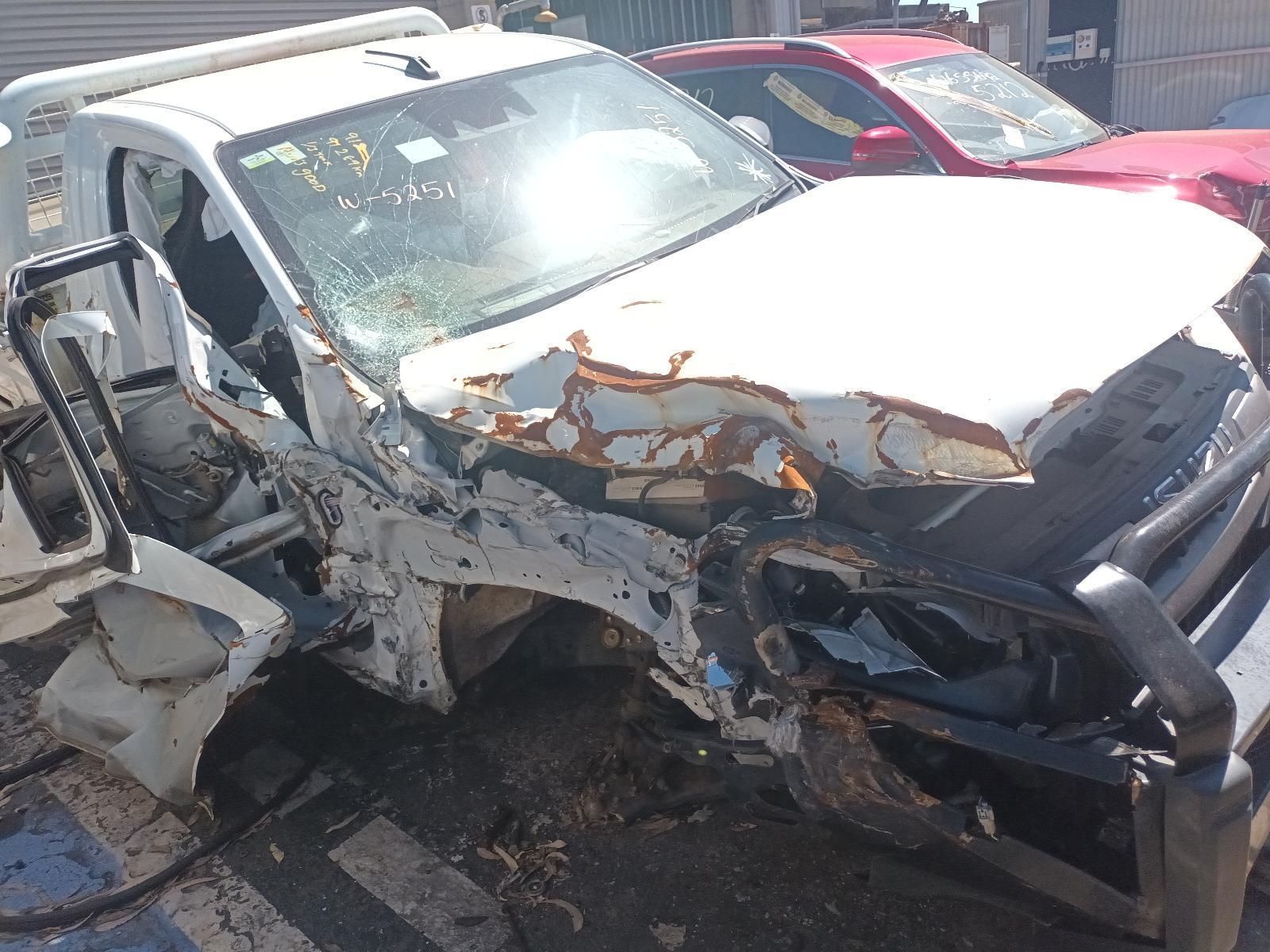 A White Car That Has Been Damaged in an Accident is Sitting on the Ground — South West 4WD Wreckers in Harristown, QLD