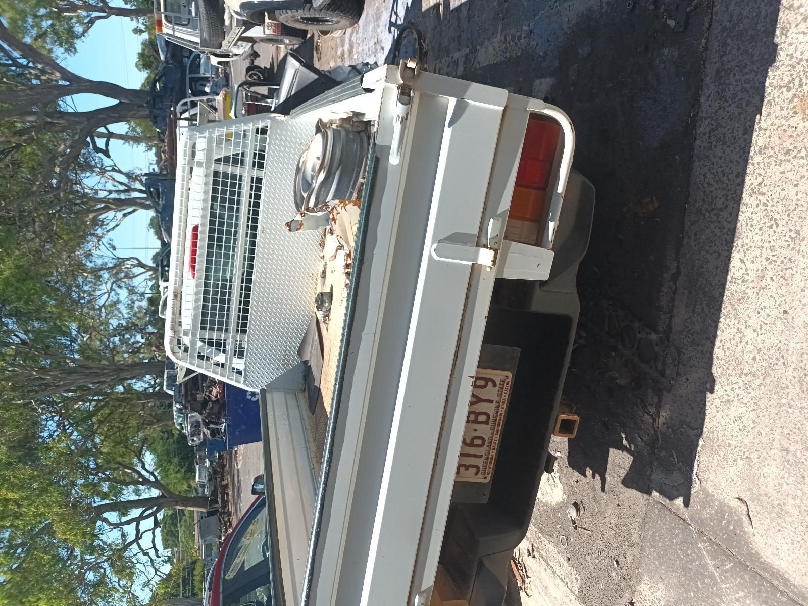 A White Truck with a License Plate That Says 316 BYG — South West 4WD Wreckers in Harristown, QLD